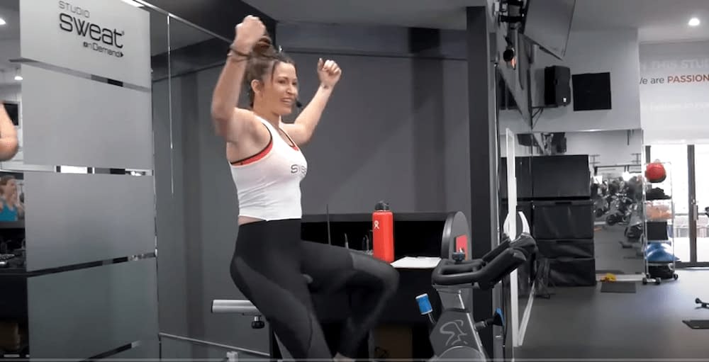 woman and HIIT cycling