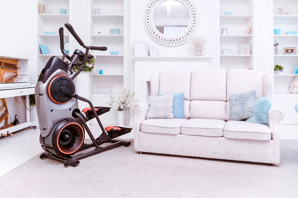 Front drive elliptical machine in a corner of the living room