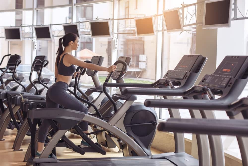 Woman training with an elliptical machine in the gym