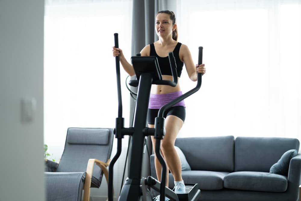 Woman exercising on an elliptical cross trainer