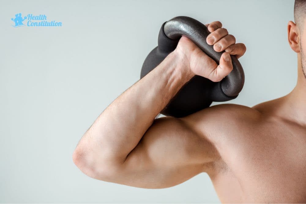 Man Holding Kettlebell with His Right Hand