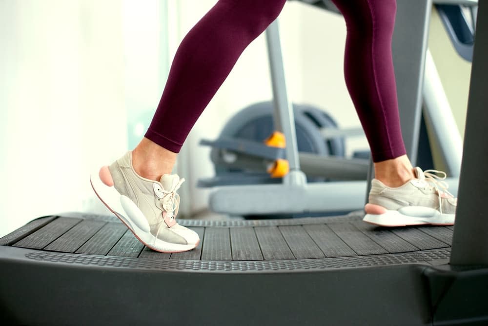 Woman Training on a Curved Treadmill