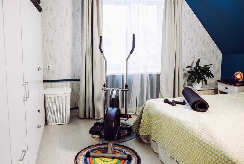 An elliptical cross trainer in a bedroom