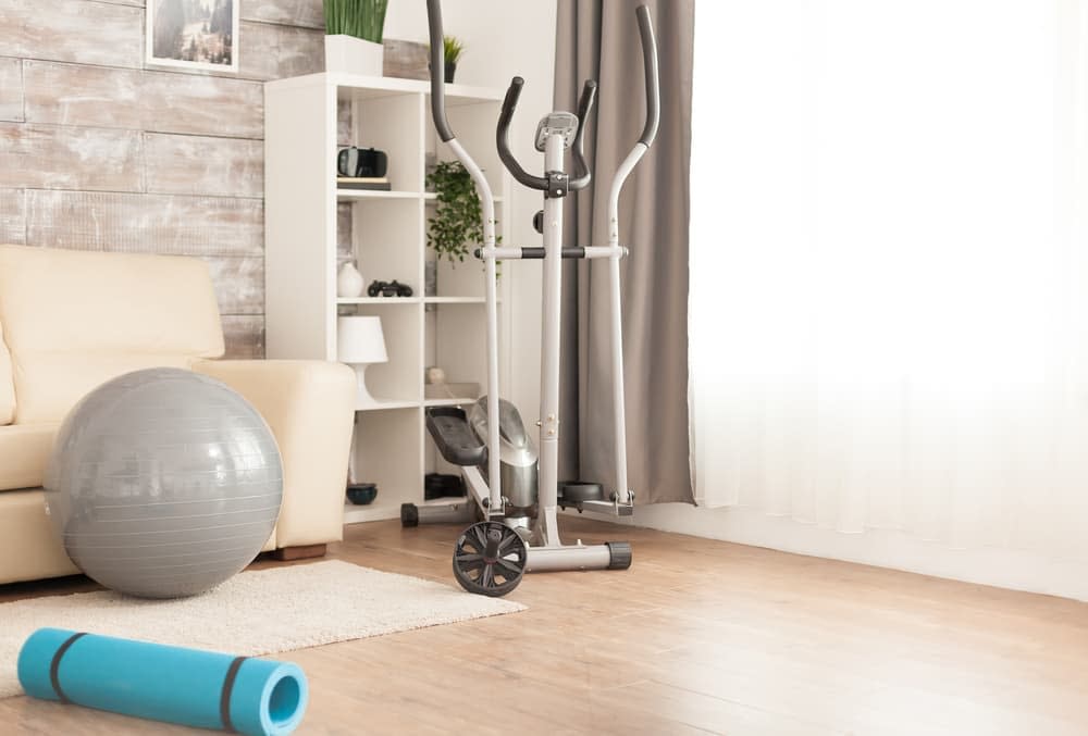 An elliptical machine at the corner of the living room