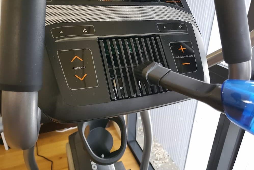 Vacuuming the fan of an elliptical cross trainer