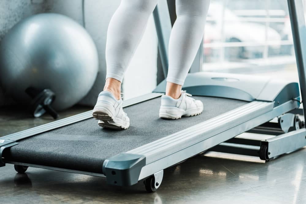 Woman Training on a Flat Treadmill
